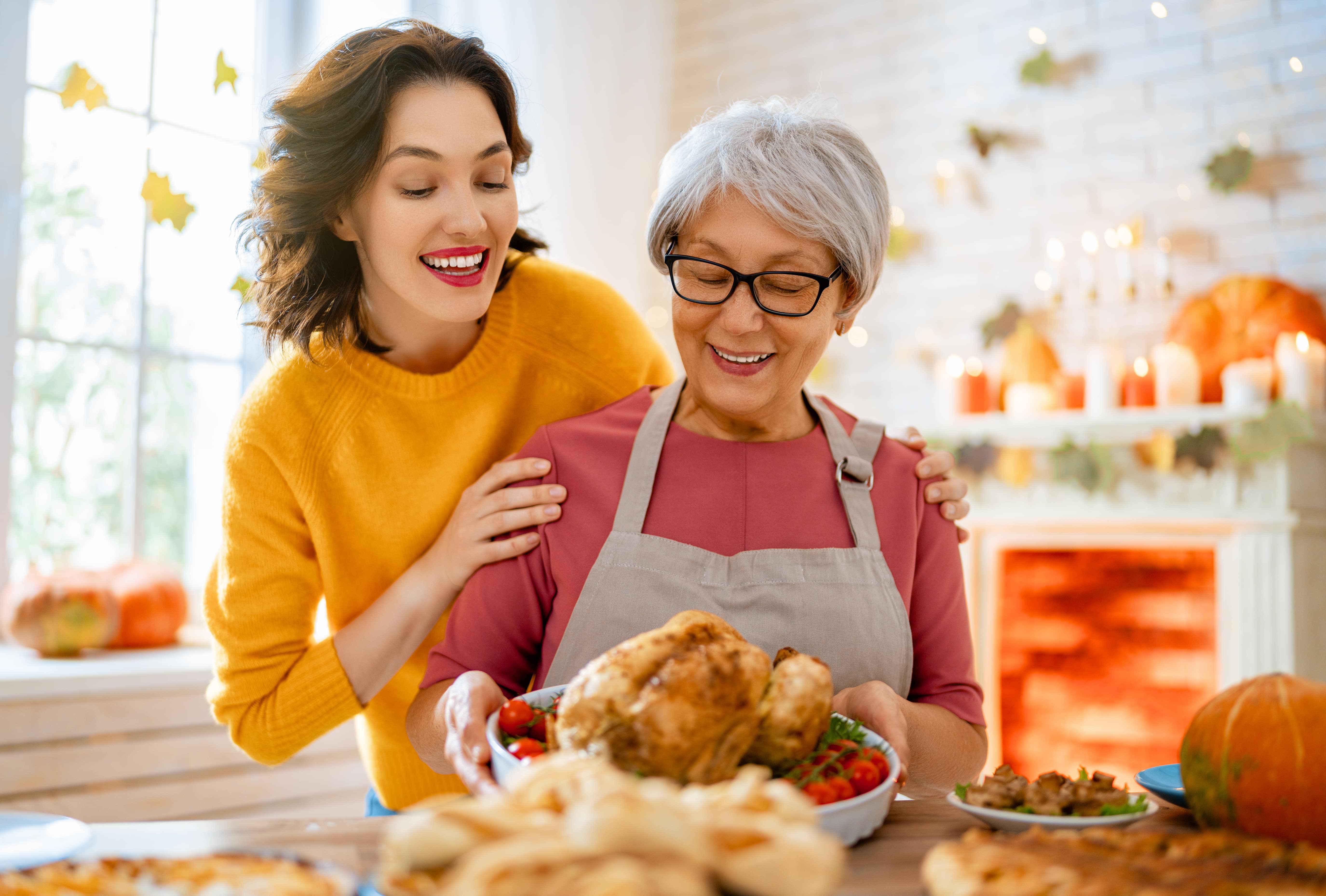 A caregiver preparing a holiday meal together with an older loved one
