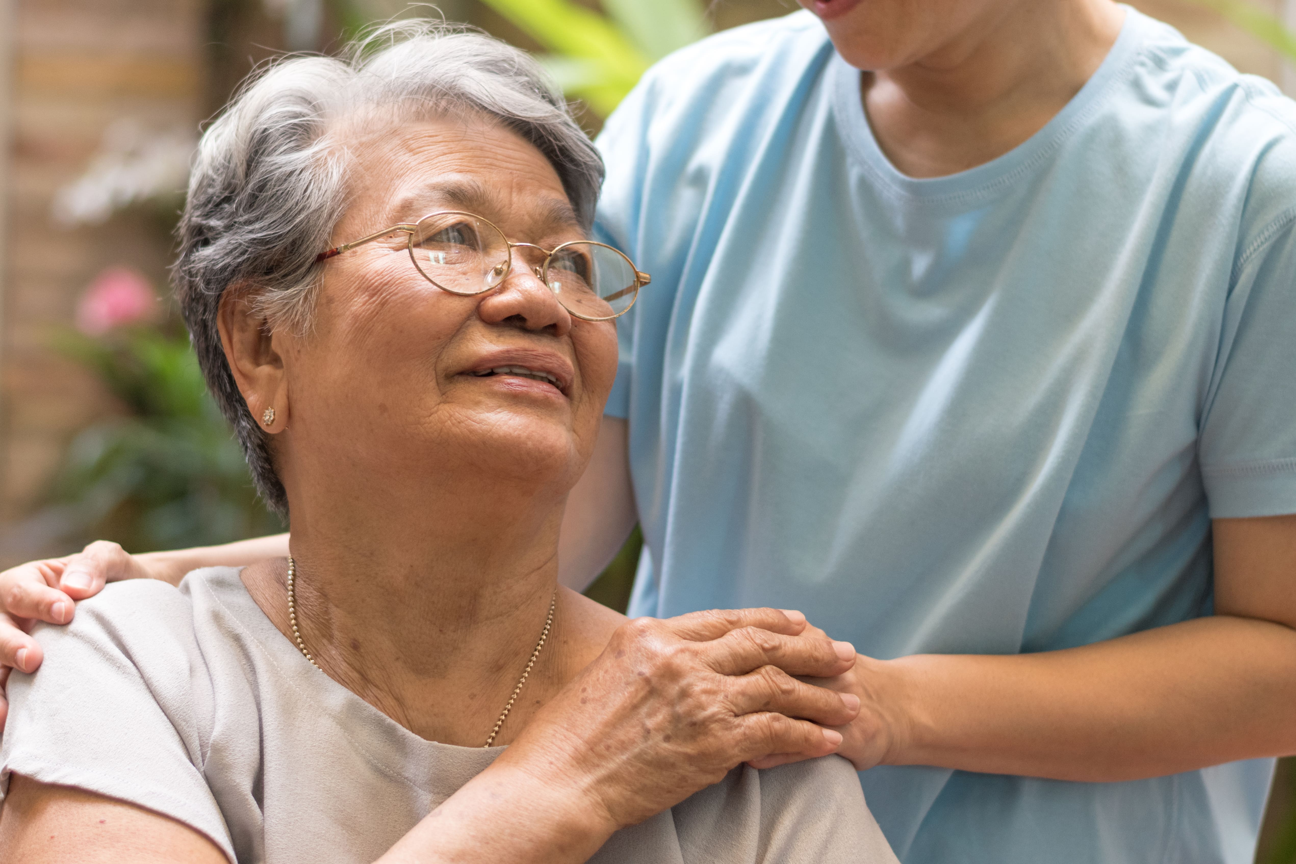 A caregiver comforting an older adult