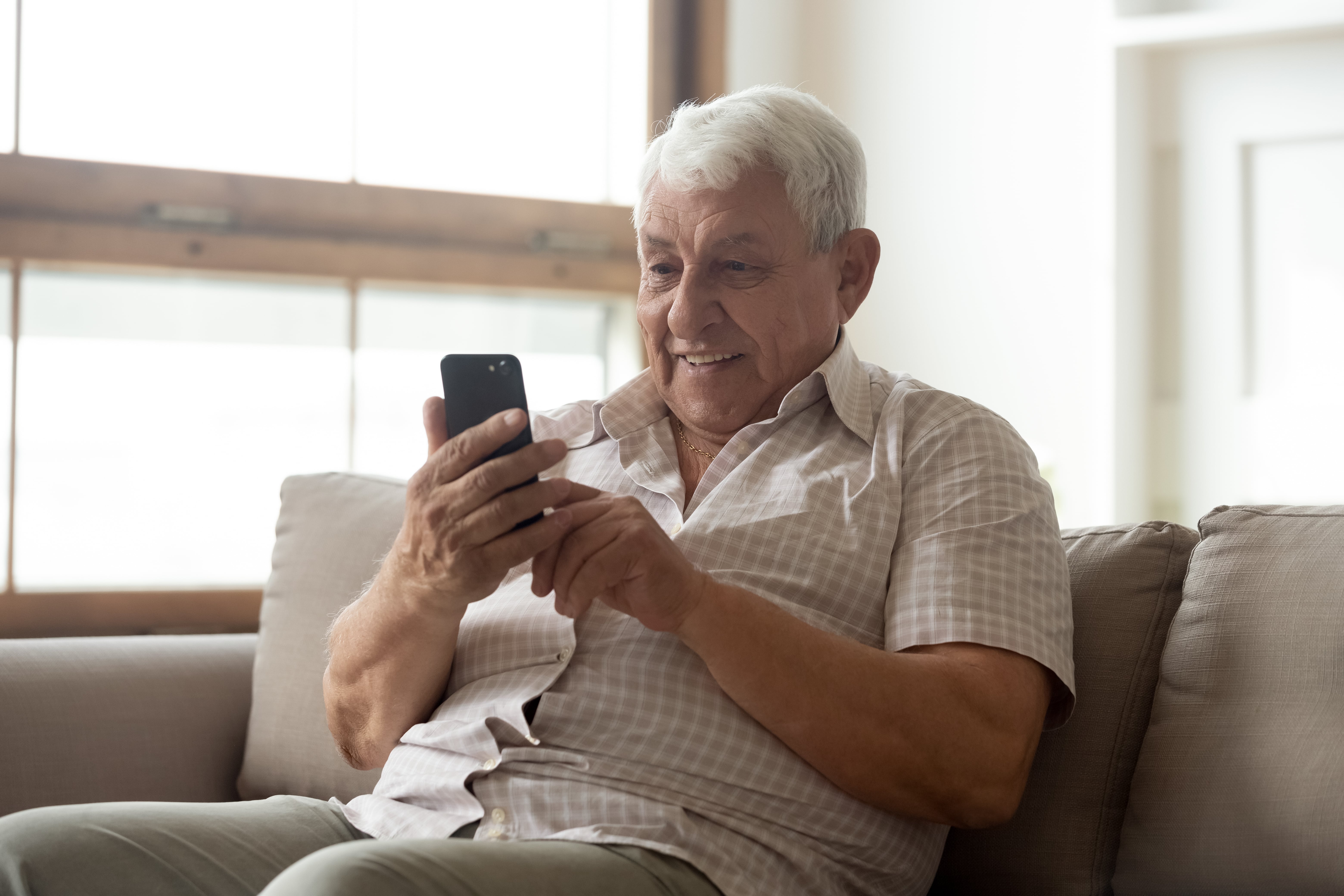 An older adult using cell phone technology