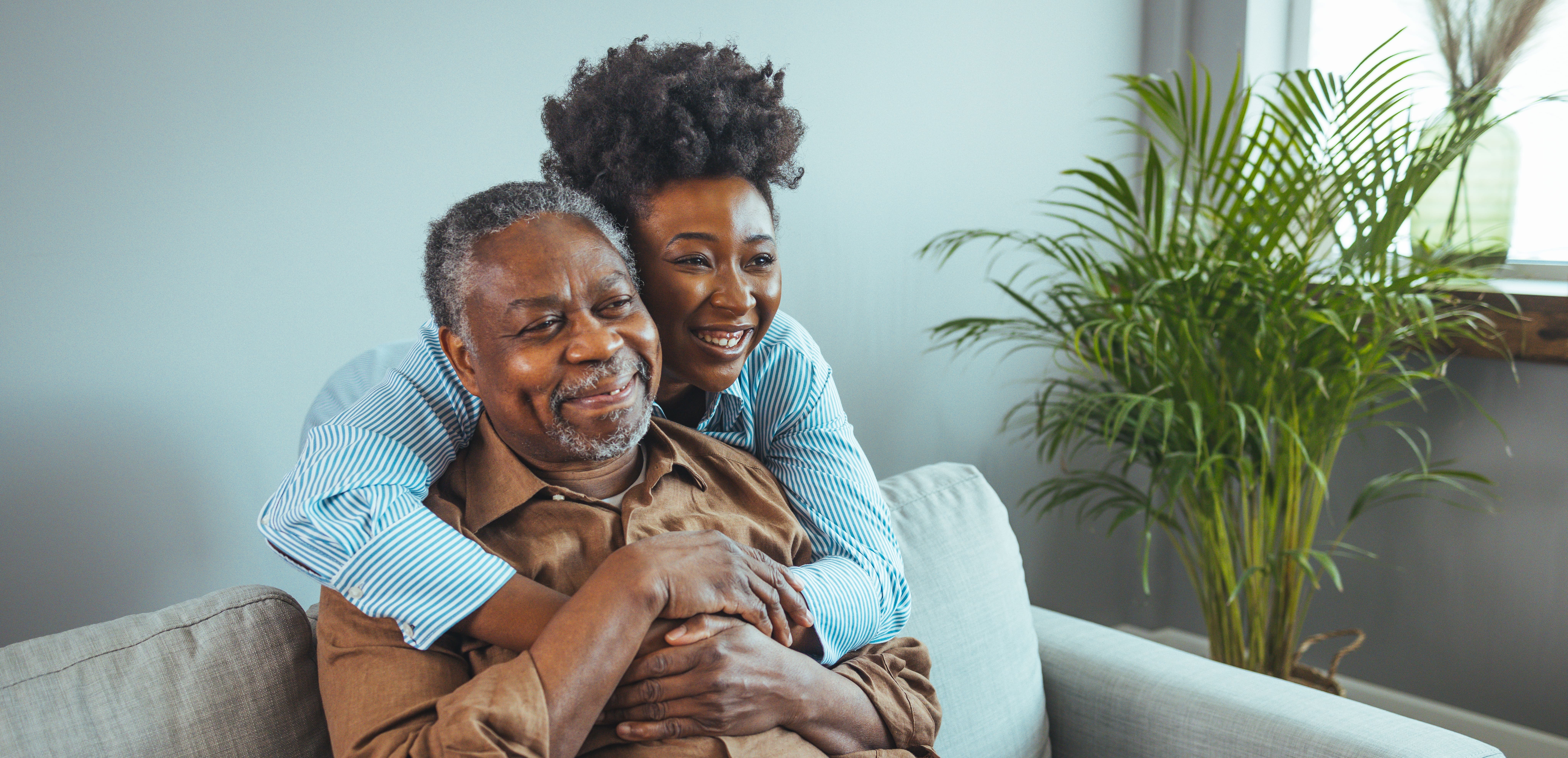 A caregiver embracing her older loved one