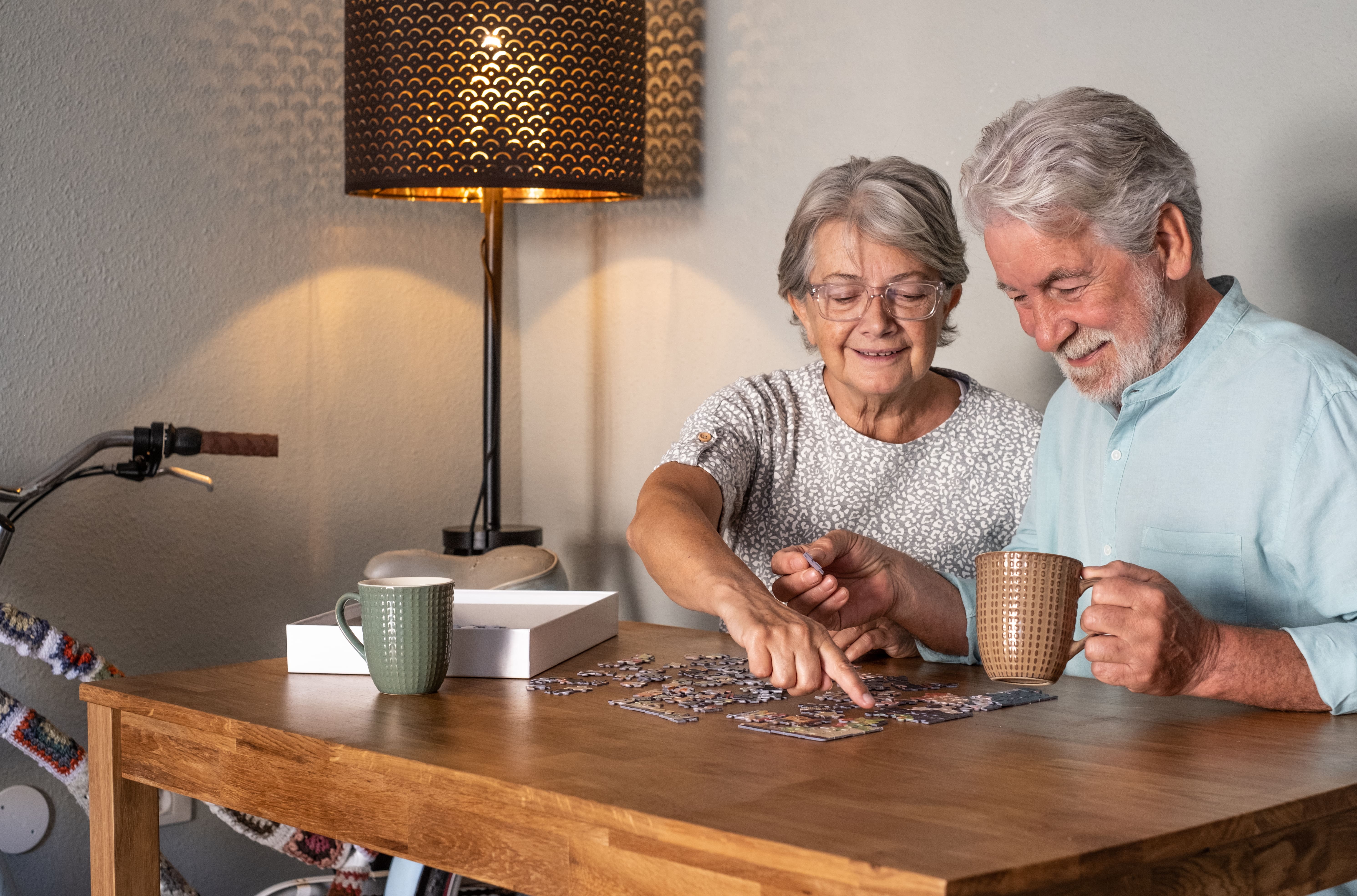 An older couple doing a puzzle together