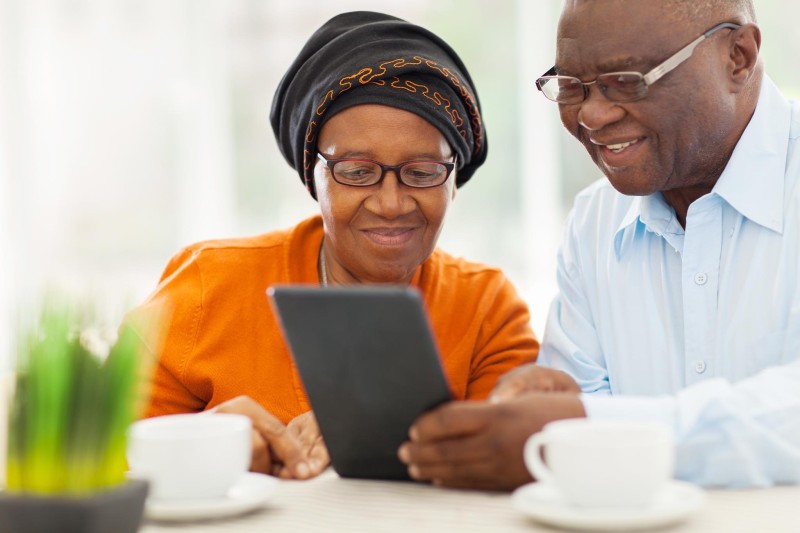 An older couple reviewing their options on a tablet