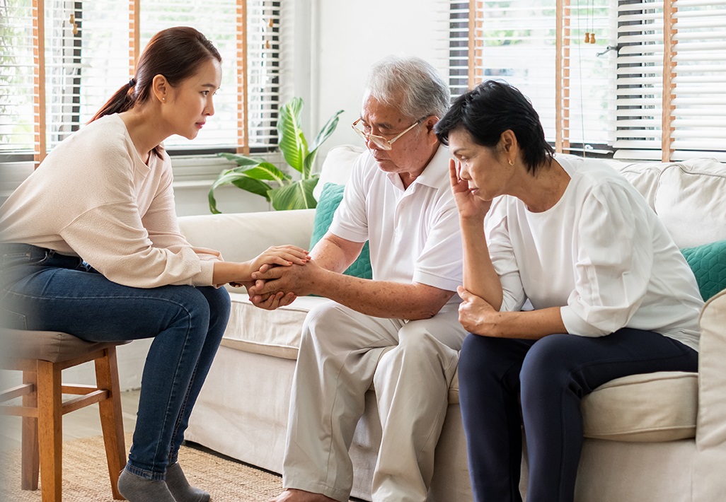 A caregiver having a difficult conversation with her older loved ones