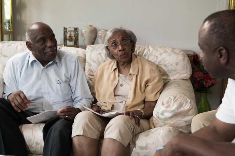 An older couple discussing concerns with a counselor