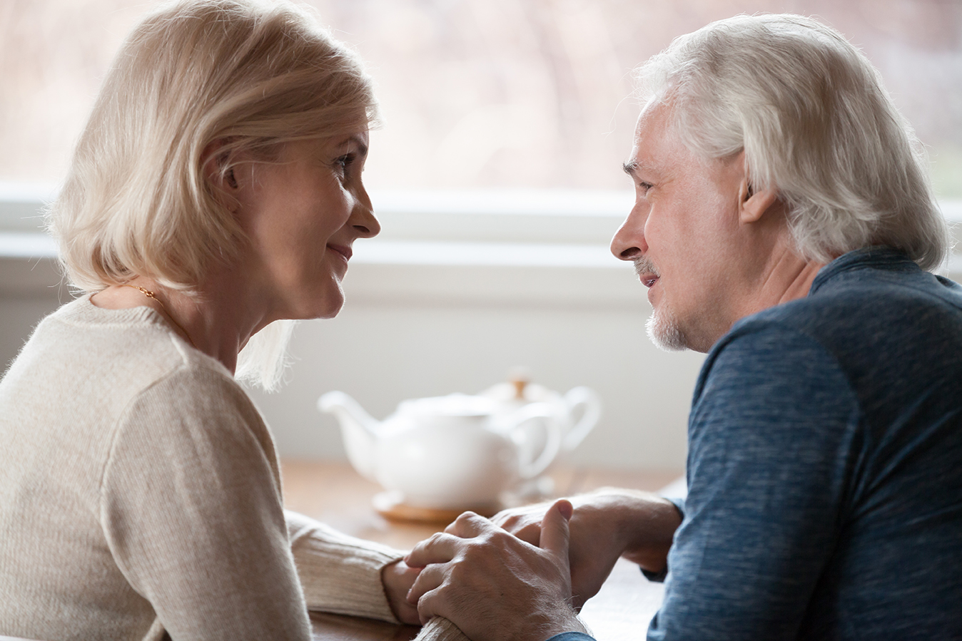A caregiver and older adult enjoying a conversation